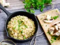 Kremowe risotto z grzybami, posypane natką pietruszki. Idealne, gdy szukasz czegoś co zamiast wina do risotto.