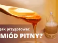 Jak przygotować miód pitny? Złocisty miód spływa z łyżki, obok fermentuje w balonie.