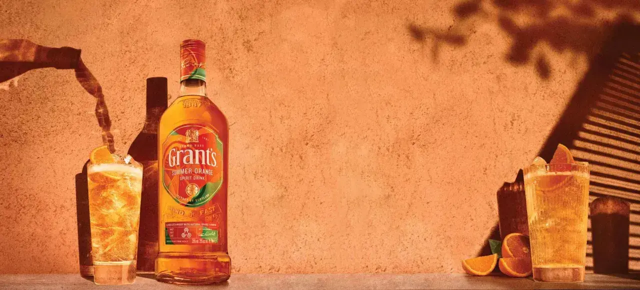 Orzeźwiający Grant's Summer Orange Spirit Drink z pomarańczą i lodem. Idealny przepis na letni drink.